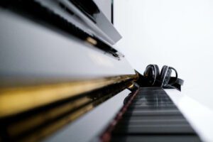 Acoustic Piano with headphones on keyboard