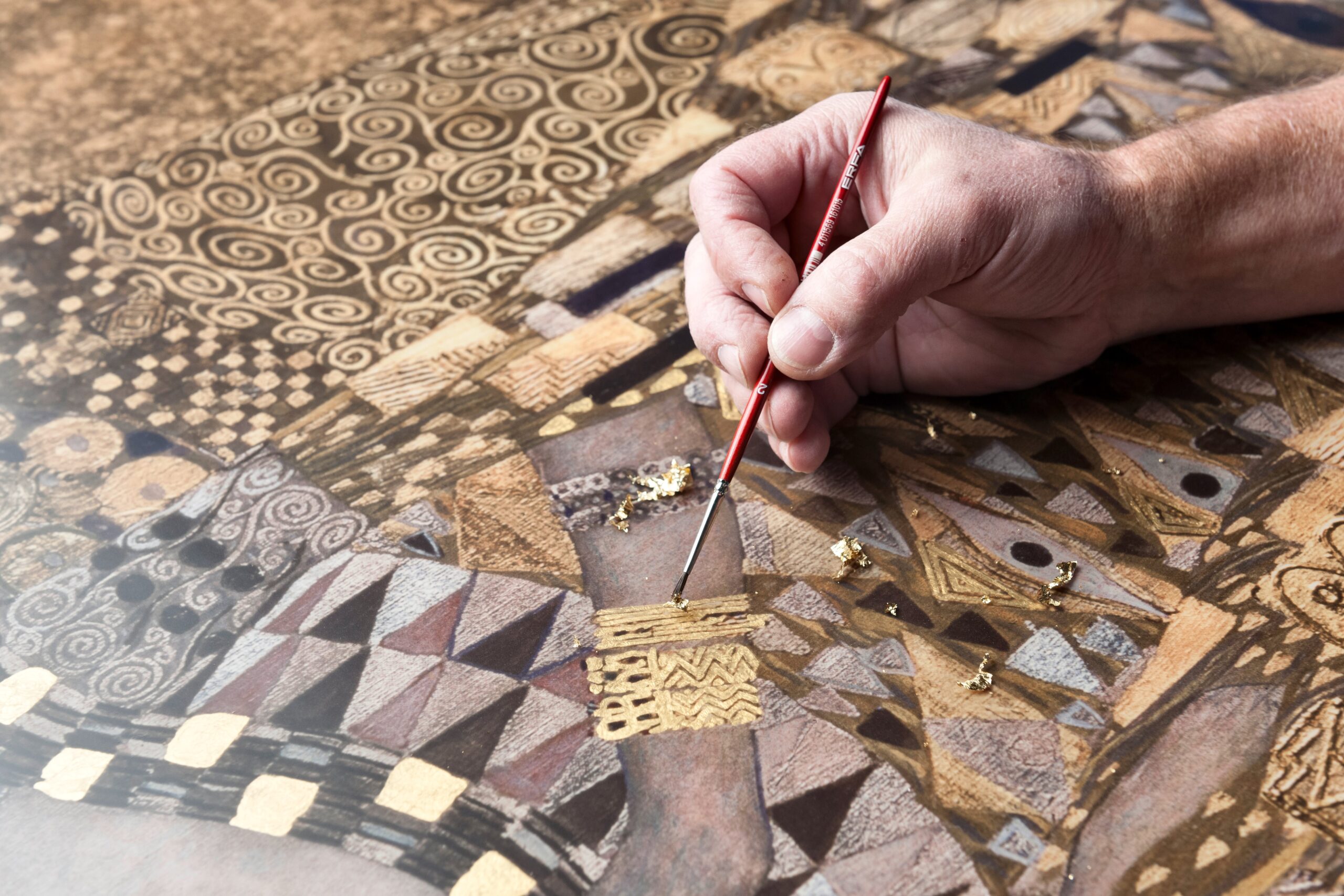 applying gold leaf close up